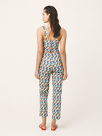 Woman wearing a patterned jumpsuit on a white background