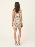 Woman wearing a floral romper on a white background