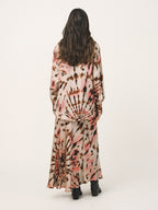 Person wearing a tie-dye outfit on a white background
