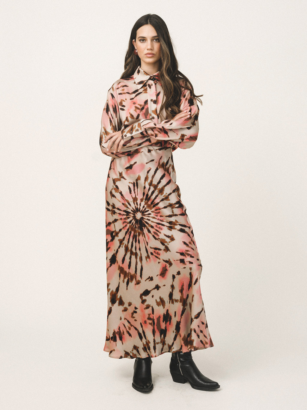 Woman wearing a tie-dye dress with a white background