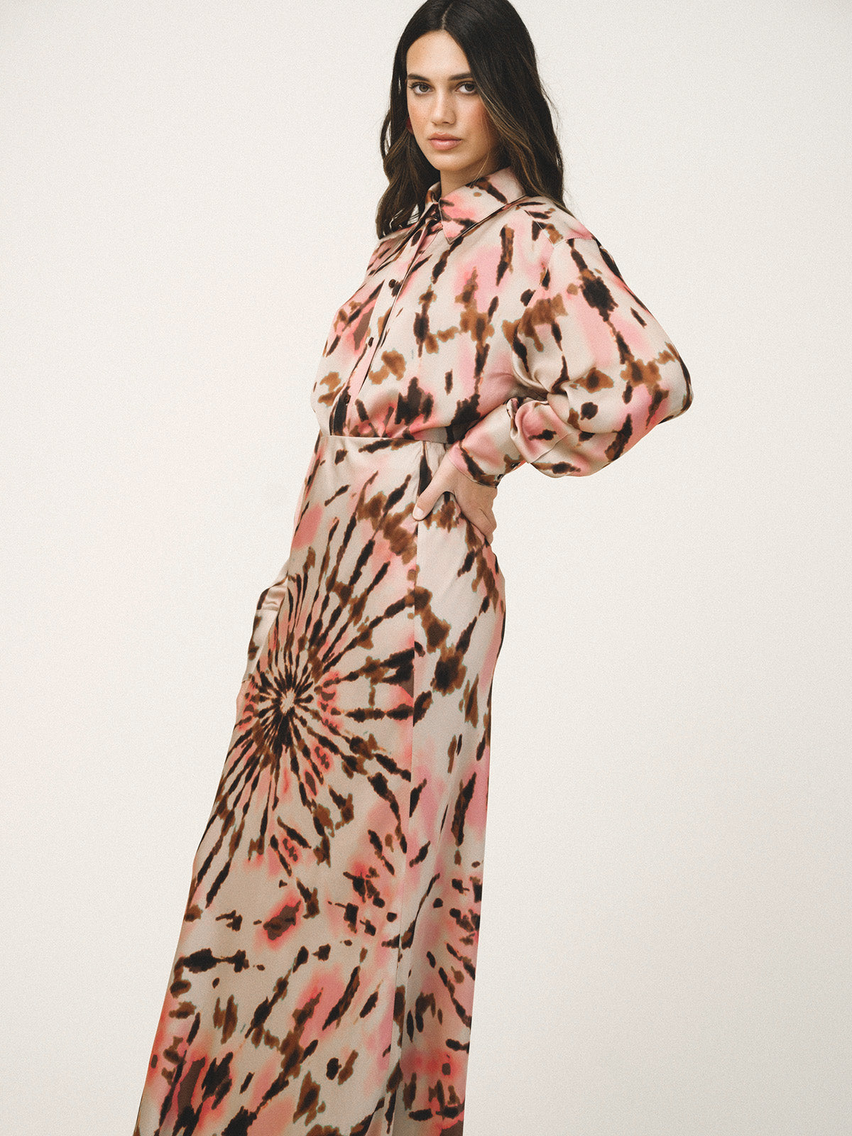 Woman wearing a tie-dye dress with a white background