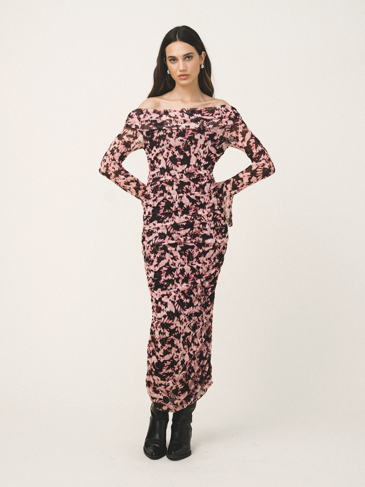 Woman wearing a floral off-shoulder dress on a white background