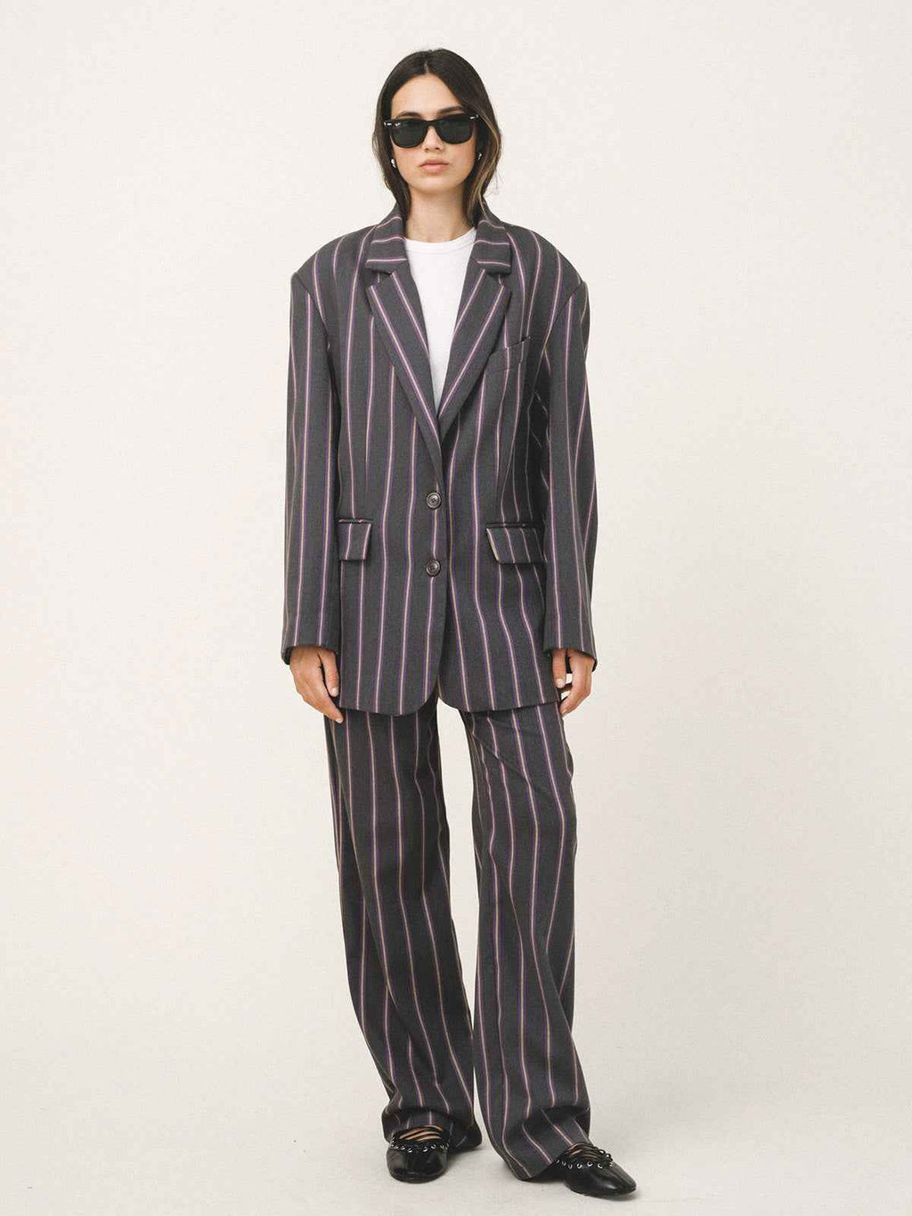 Person wearing a striped suit on a white background