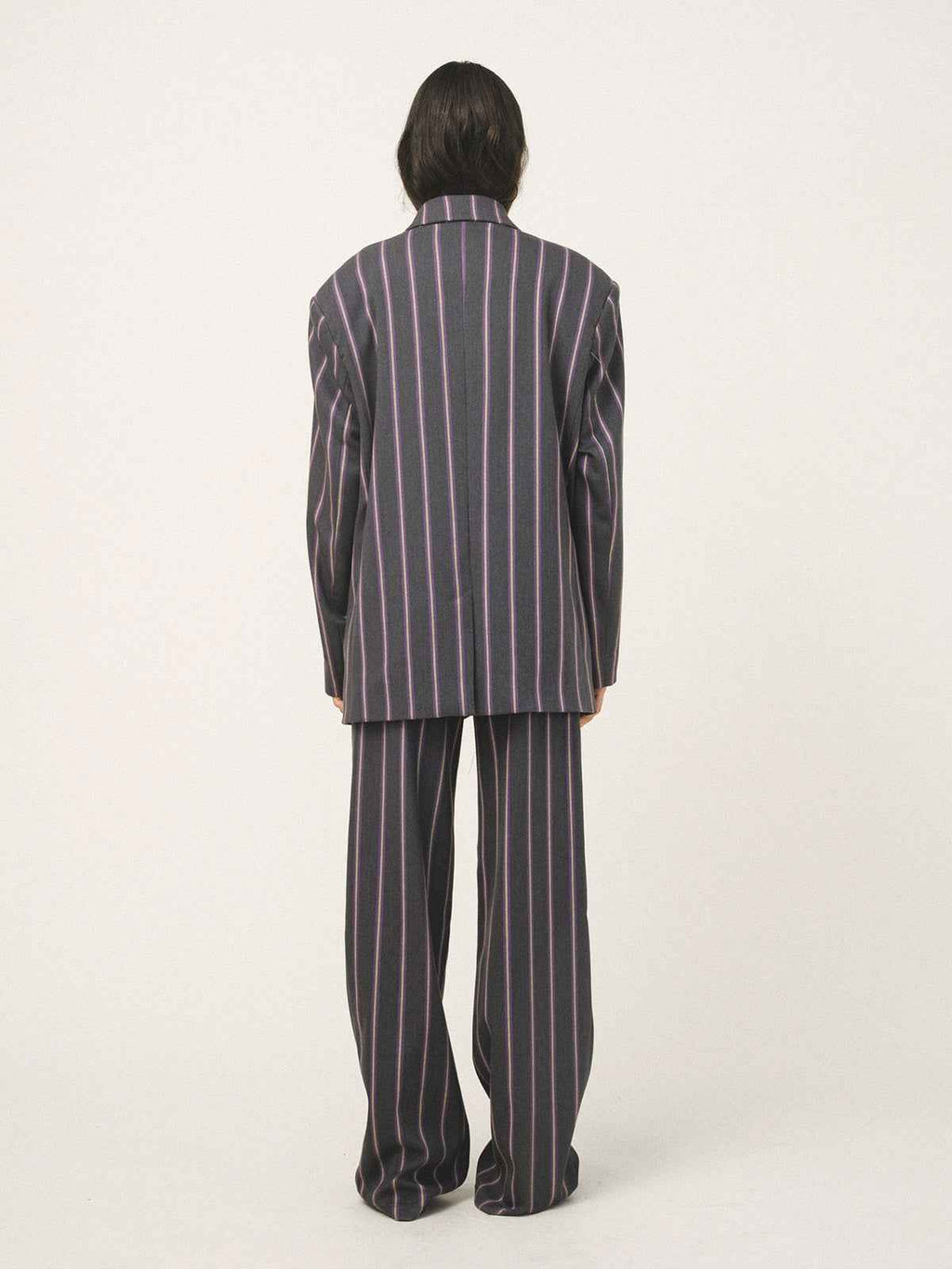 Person wearing a striped pajama set on a white background