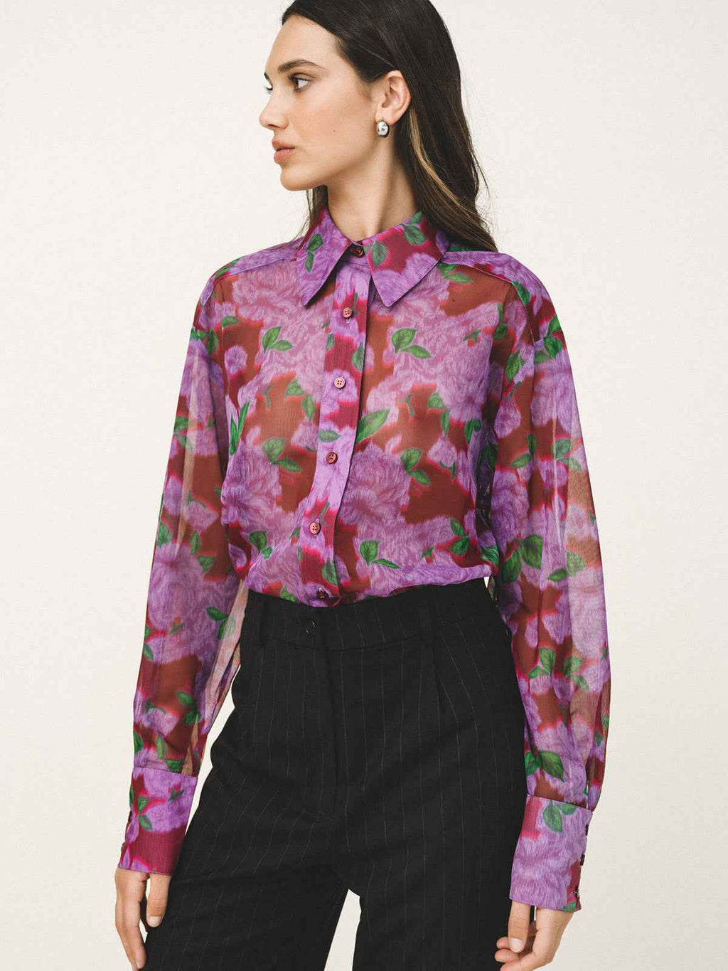 Woman wearing a floral blouse with a white background