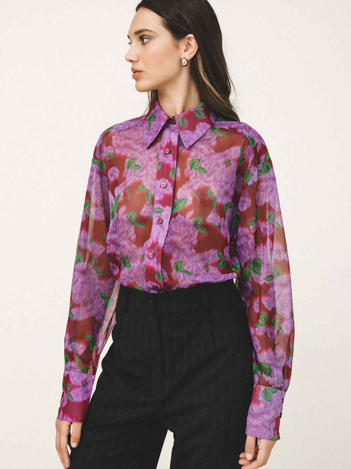 Woman wearing a floral blouse with a white background