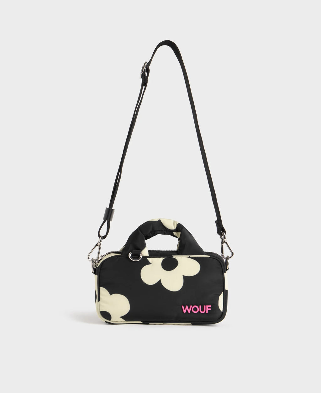 Black handbag with white floral pattern and 'WOUF' branding on a light gray background