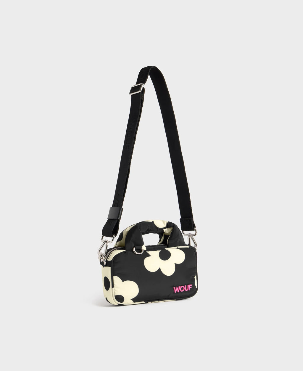 Small handbag with floral pattern and visible brand name on a light gray background