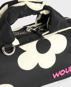 Black duffel bag with white floral pattern and pink text on a white background