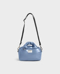 Blue handbag with a black strap on a white background
