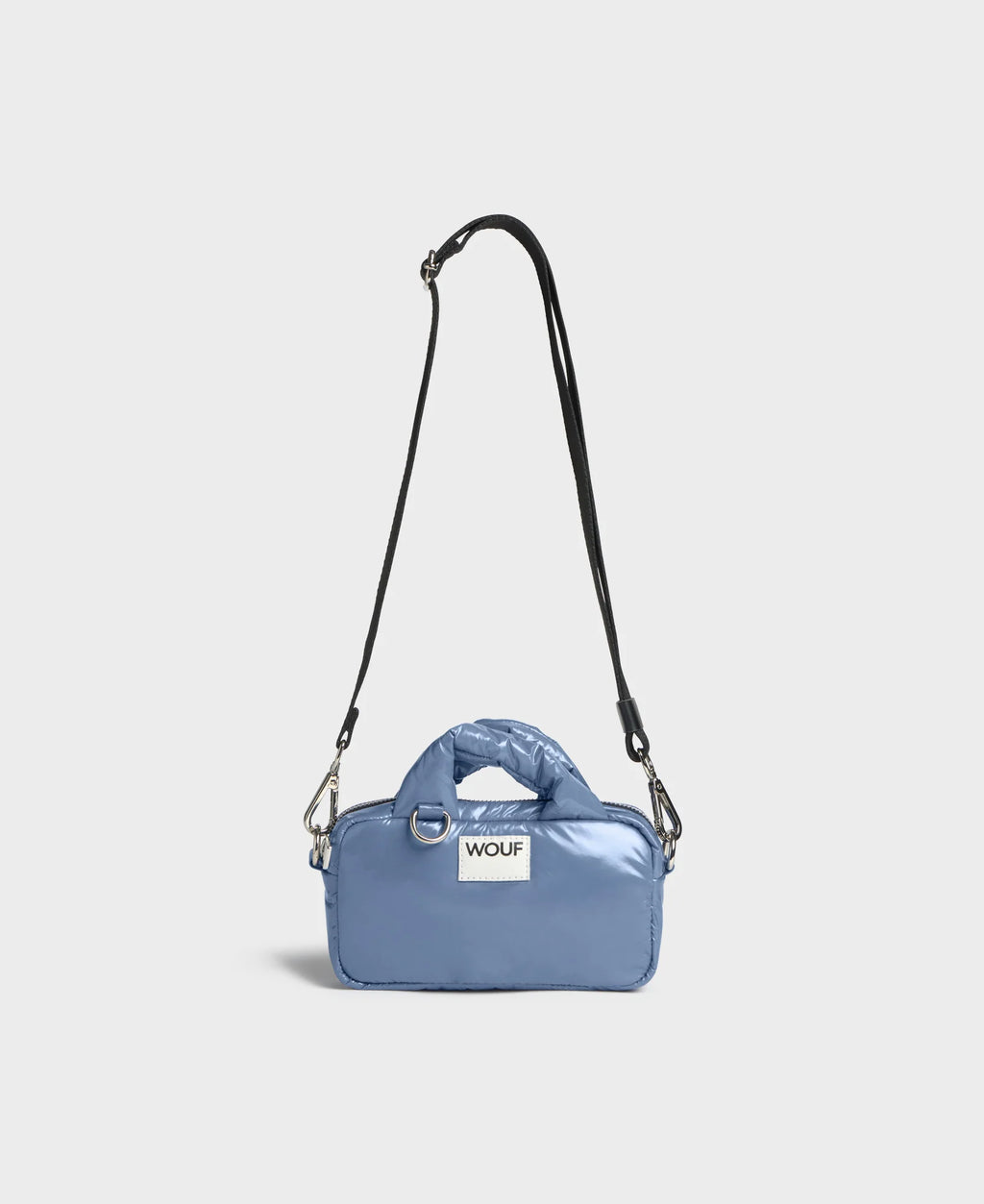 Blue handbag with a strap on a light gray background