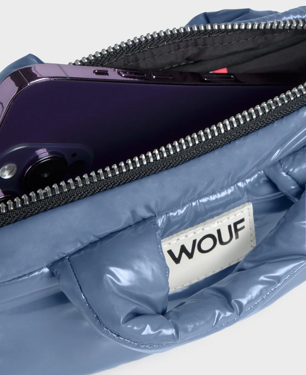 Blue bag with a visible WOUF logo on a light gray background