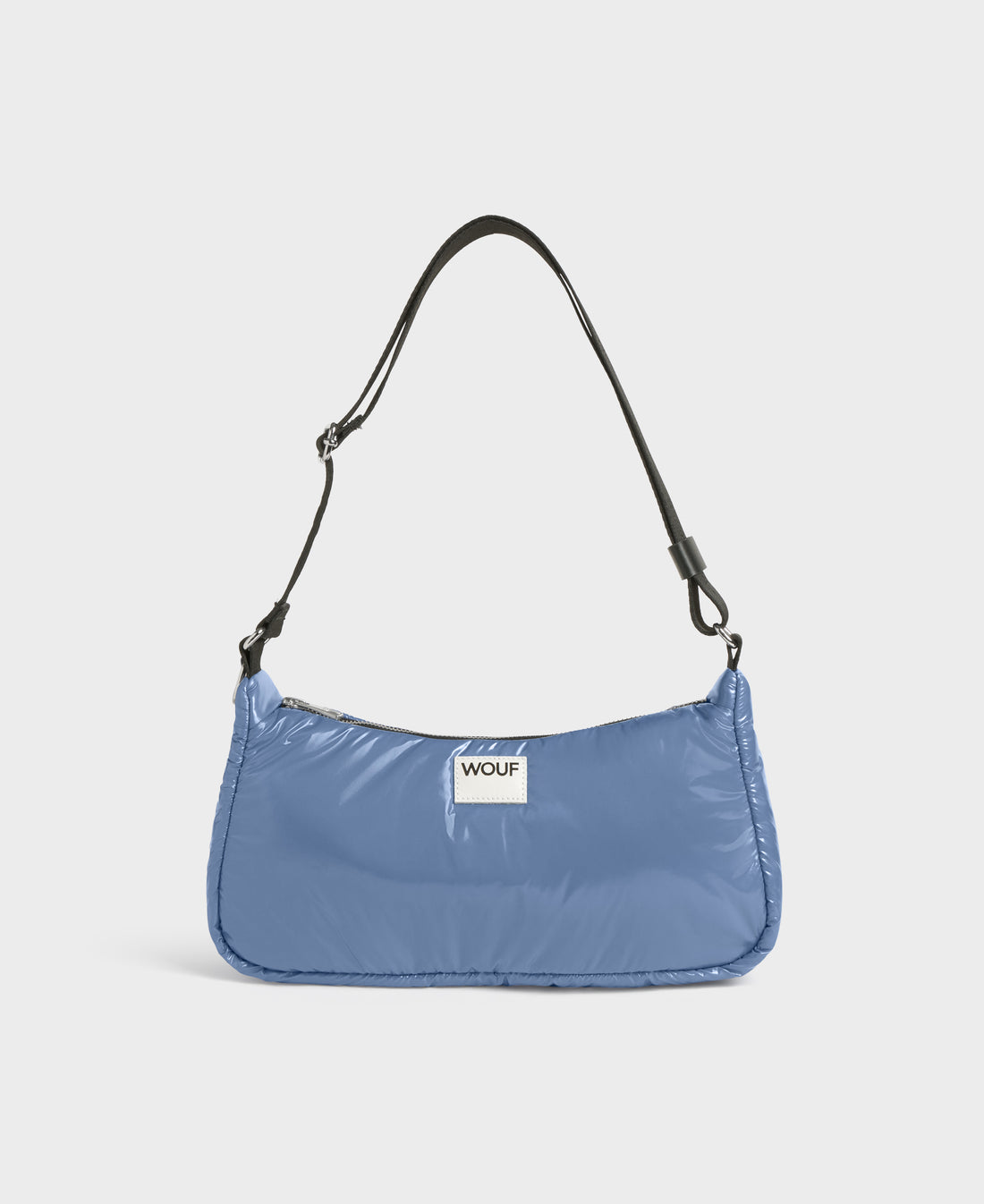 Blue shoulder bag with a visible brand label on a white background