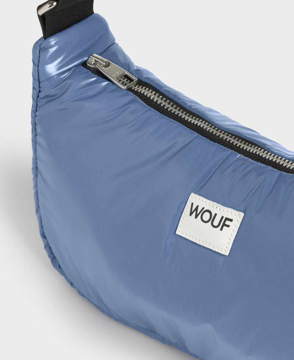 Blue fanny pack with a visible brand logo on a light gray background