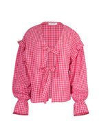 Pink and white checkered blouse with ruffled sleeves on a white background