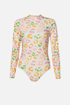 A long-sleeve bodysuit with a high mock neck, featuring an all-over pastel leopard print pattern in pink, yellow, green, and orange on a white base, shown against a light gray background.