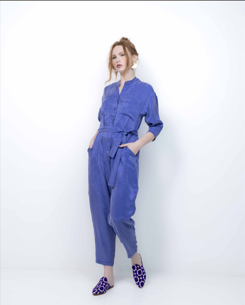 Woman wearing a blue jumpsuit on a white background