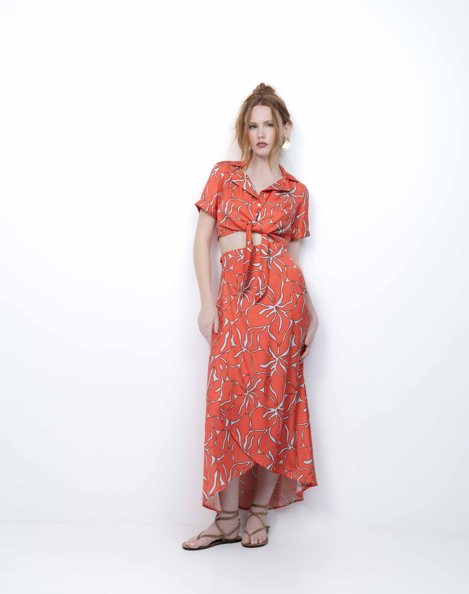 Woman wearing a red floral dress on a white background