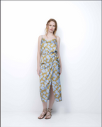Woman wearing a patterned dress on a white background