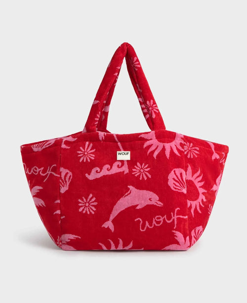 Red tote bag with pink dolphin designs and 'woof' text on a white background