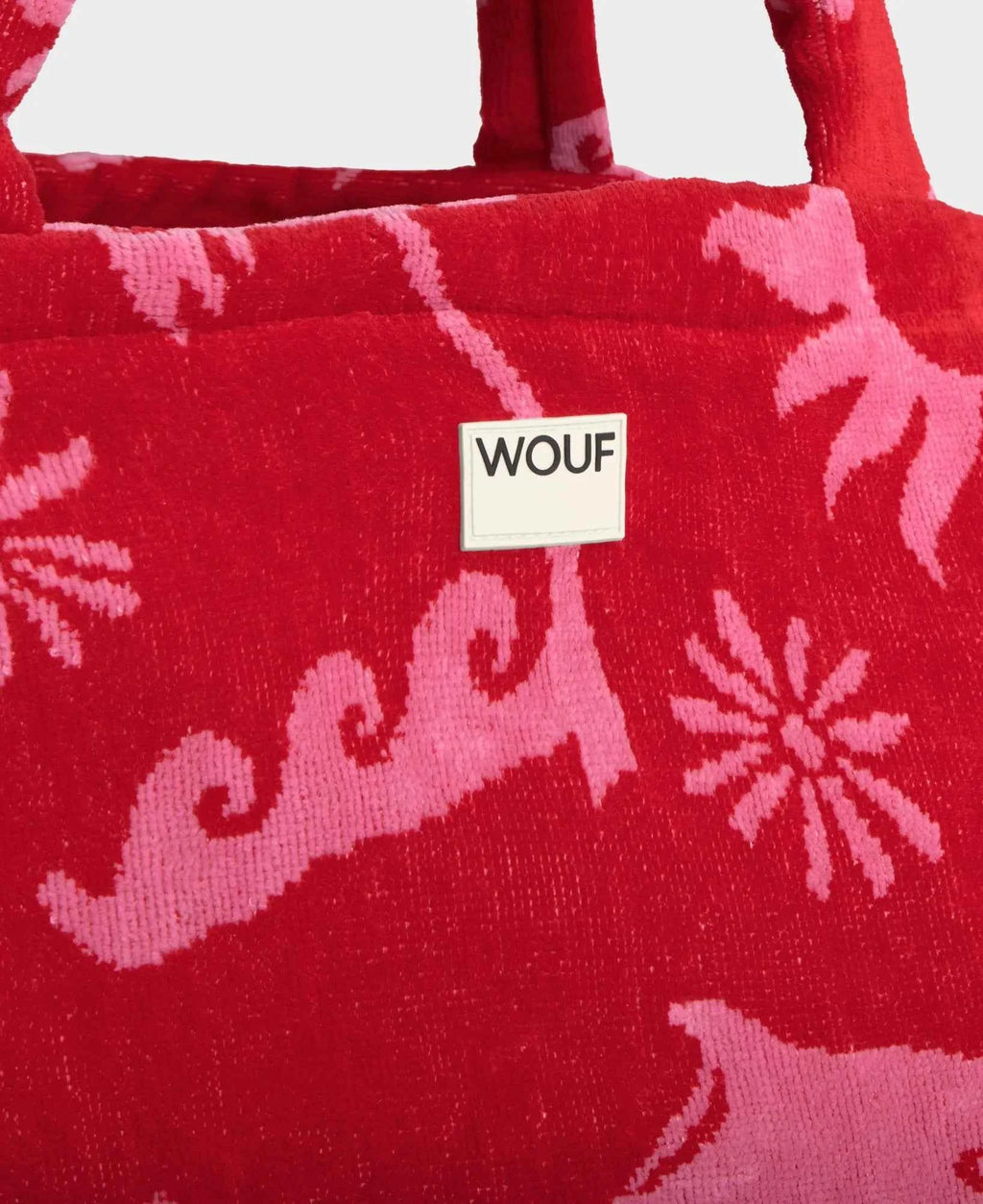 Red bag with pink patterns and a WOUF label on a white background