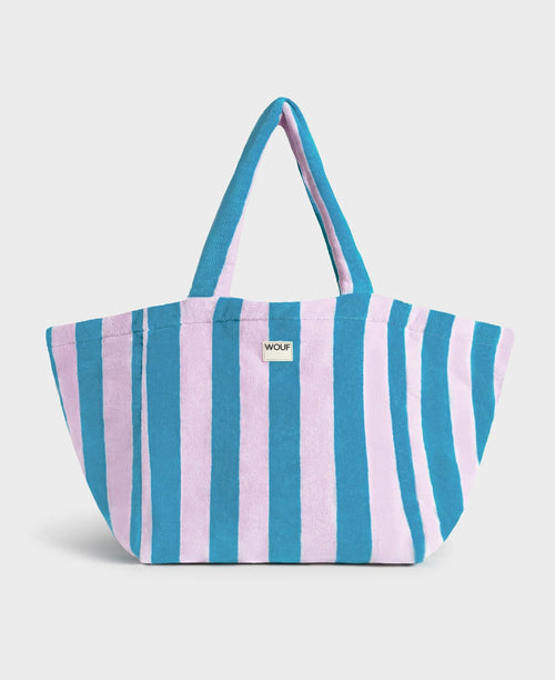 Striped tote bag with blue and pink horizontal stripes on a light gray background