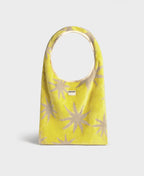 Yellow bag with beige star patterns on a white background