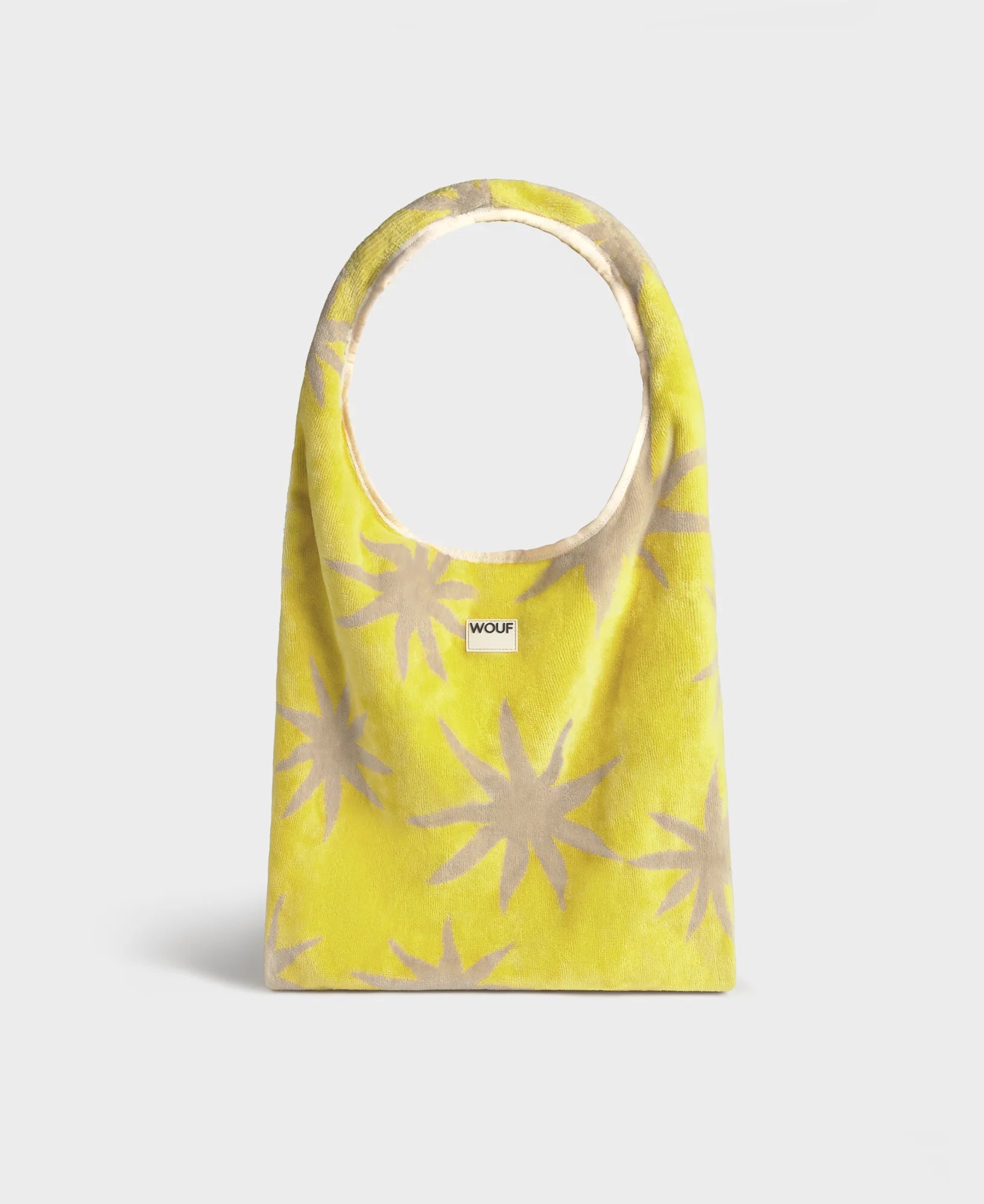 Yellow bag with beige star patterns on a white background