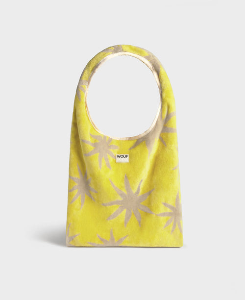 Yellow bag with beige star patterns on a white background