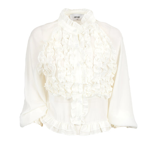 An off-white long-sleeve blouse featuring a high ruffled collar, a layered ruffle bib front, and a ruffled hemline, shown against a plain white background.