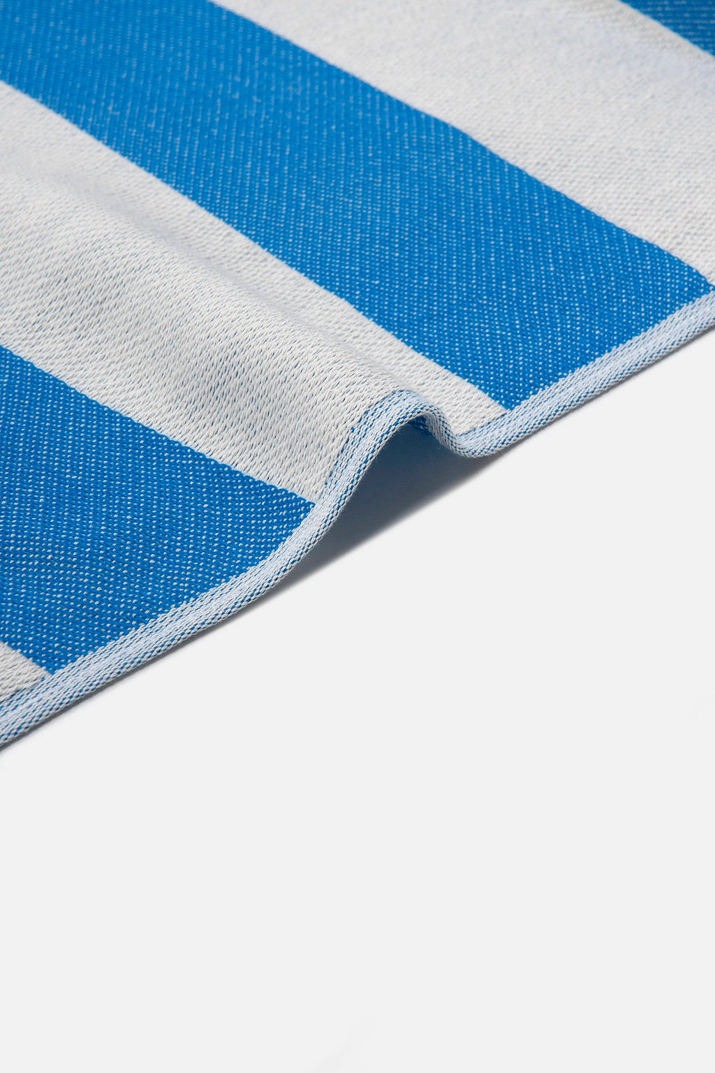 Close-up of a blue and gray striped fabric on a white background