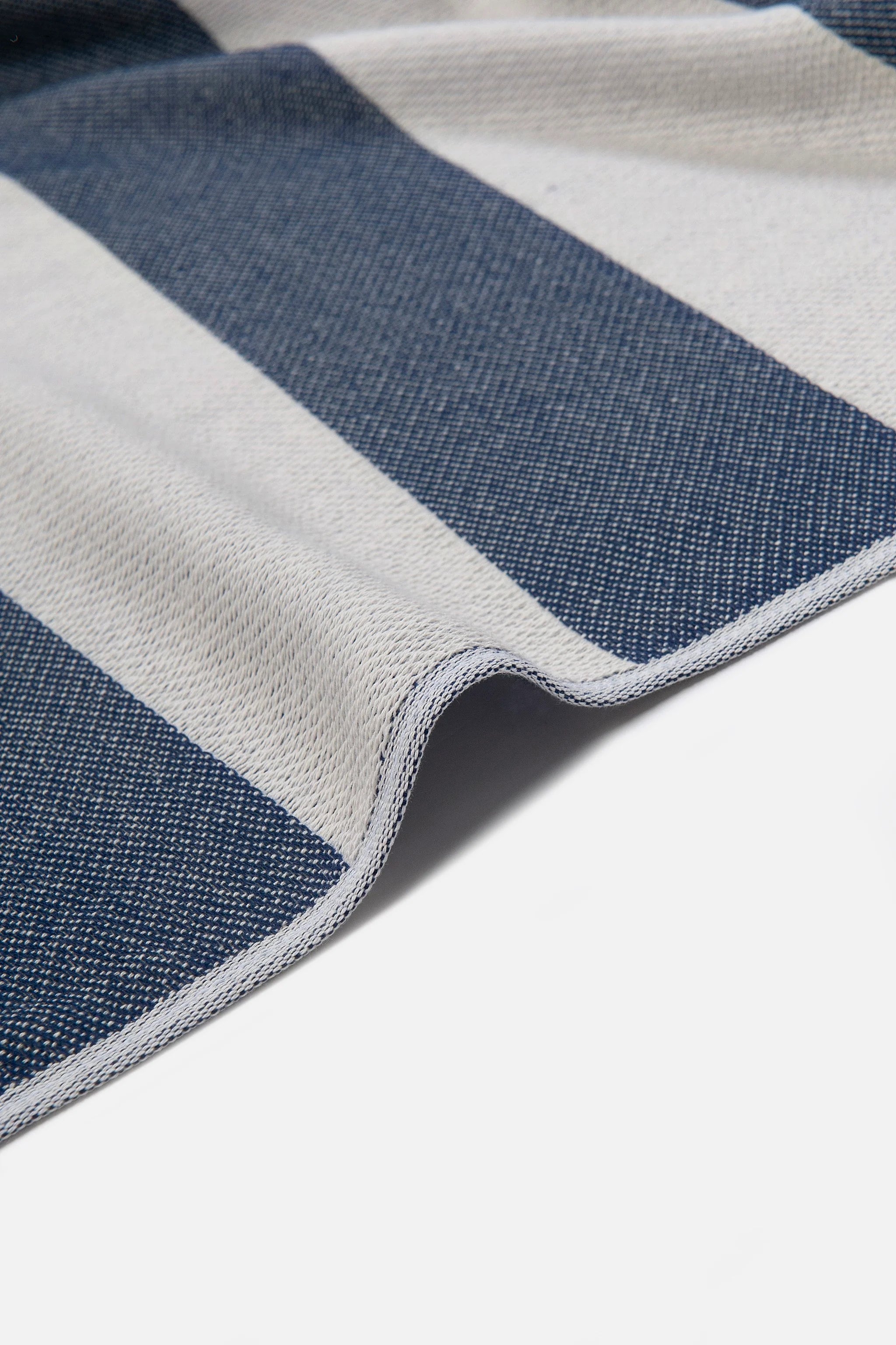 Close-up of a blue and gray striped fabric on a white background