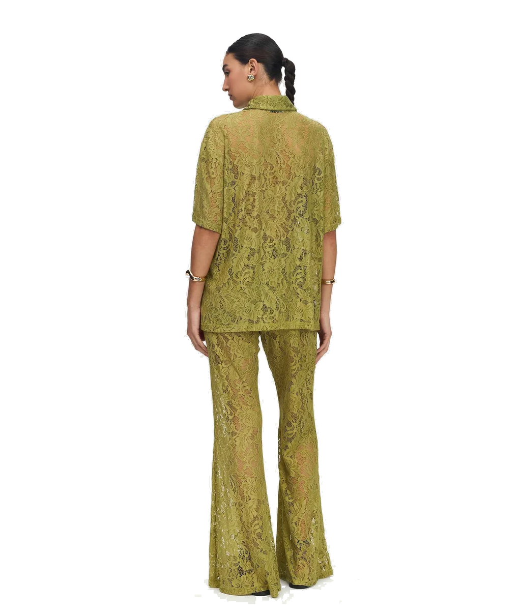 A woman shown from the back wearing a matching olive green lace two-piece set consisting of a short-sleeve collared top and flared pants, photographed against a plain white background.