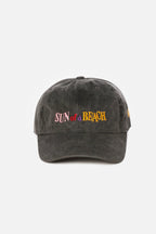 Black cap with 'Sun of a Beach' text on a white background