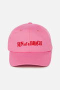 Pink cap with 'Sun of a Beach' text on a white background
