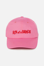 Pink cap with 'Sun of a Beach' text on a white background