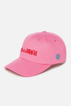 Pink cap with red text and blue logo on a white background