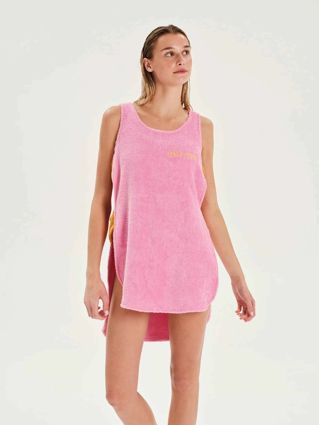 Woman wearing a pink sleeveless dress on a white background