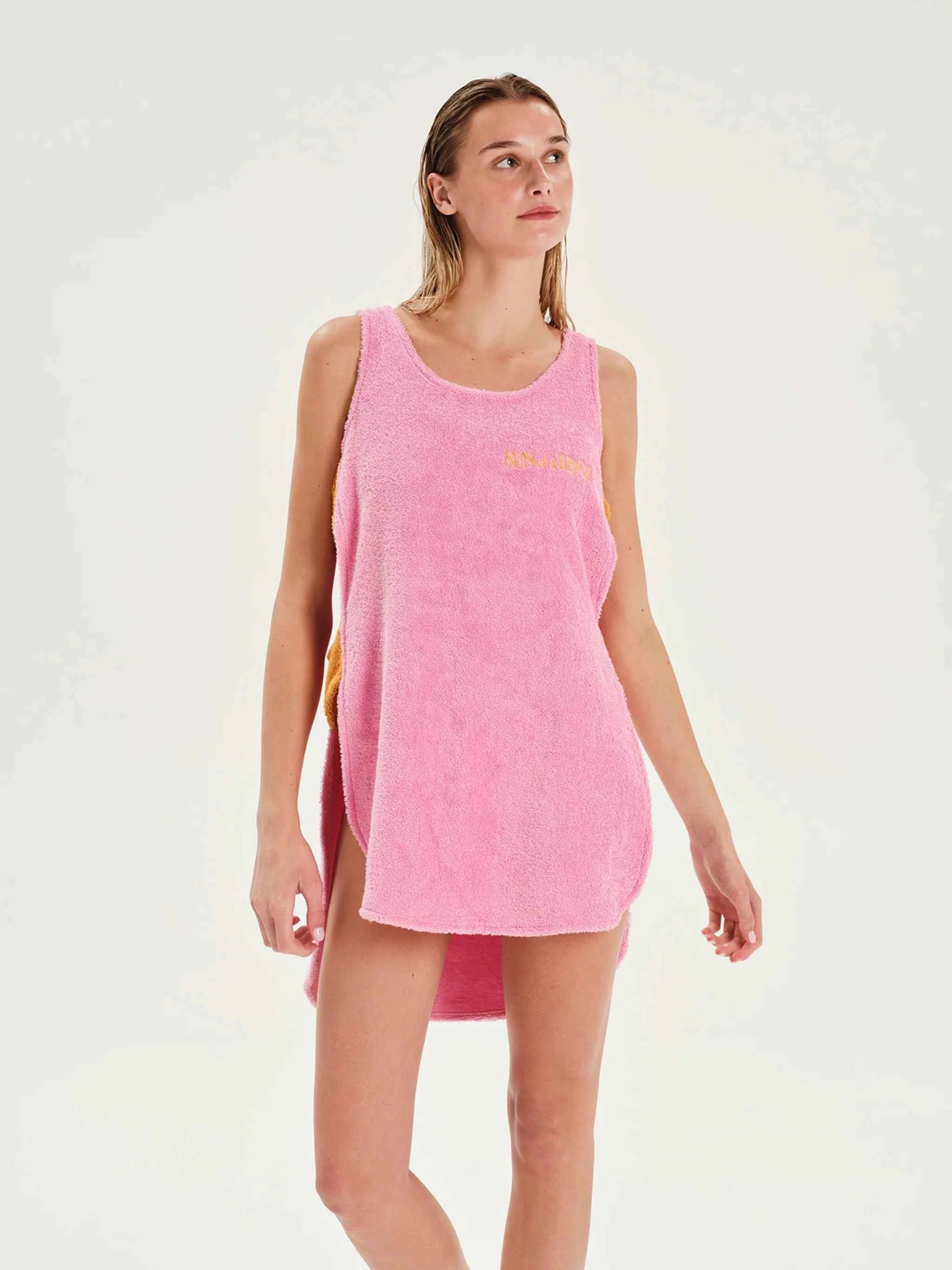 Woman wearing a pink sleeveless dress on a white background