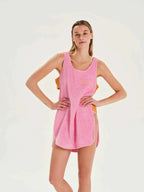 Woman wearing a pink towel dress with text on a white background