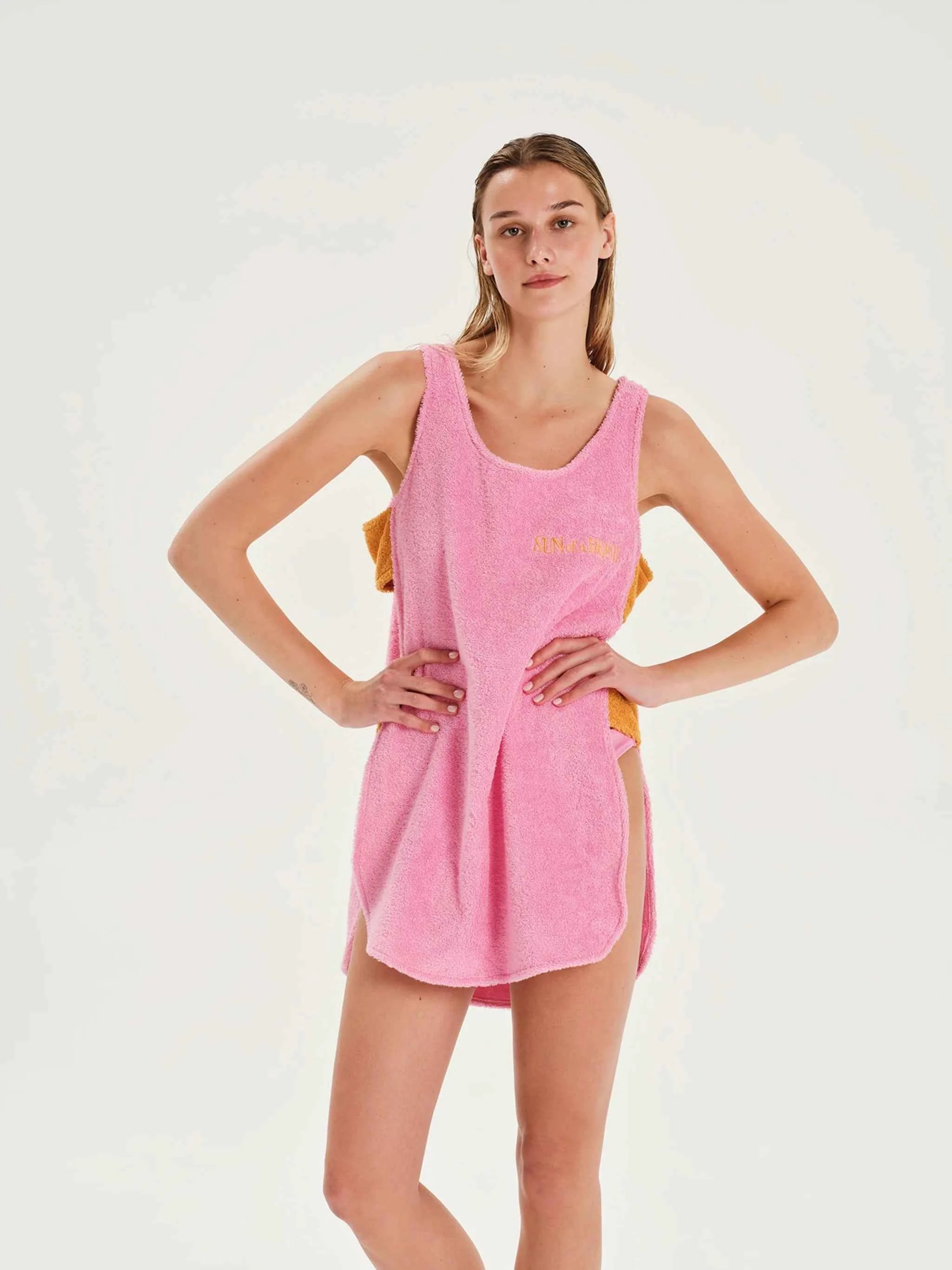 Woman wearing a pink towel dress with text on a white background