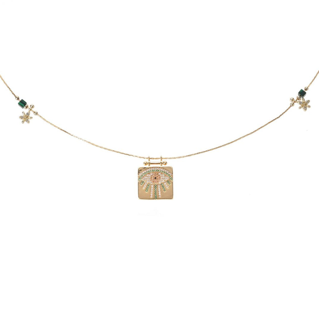 Necklace with a gold pendant featuring a floral design on a white background