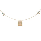 Necklace with a gold pendant featuring a floral design on a white background
