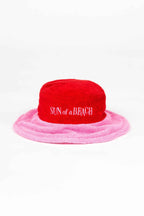 Red and pink bucket hat with 'Sun of a Beach' text on a white background