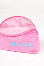 Pink pouch with 'Sun of a Beach' text on a white background
