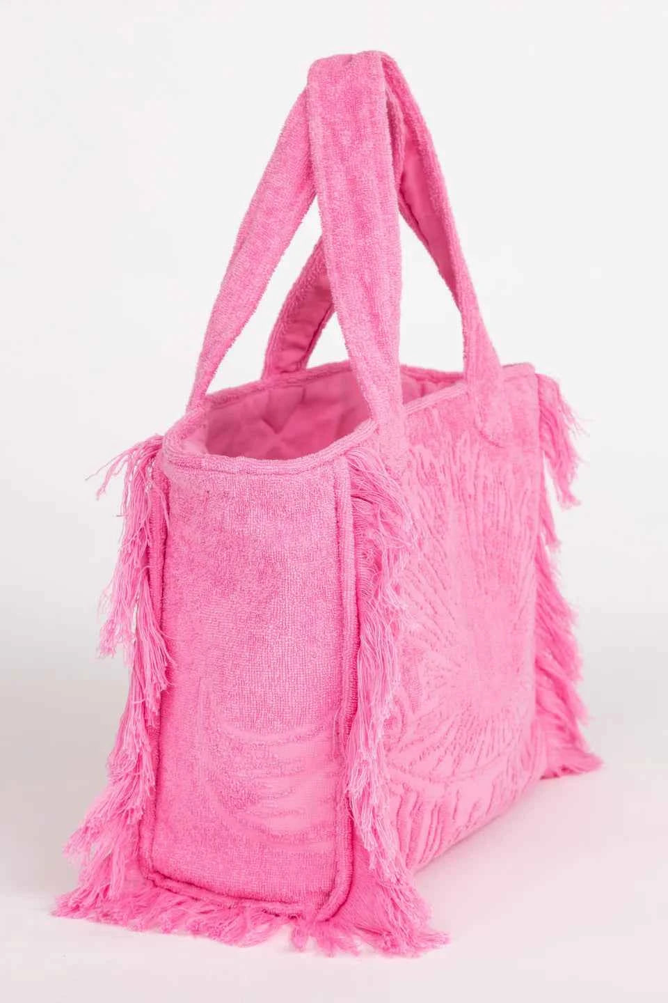 Pink tote bag with fringes on a white background