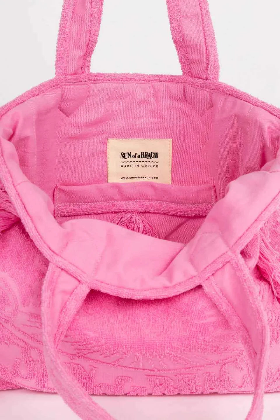 Pink textured bag with a visible brand label on a light background