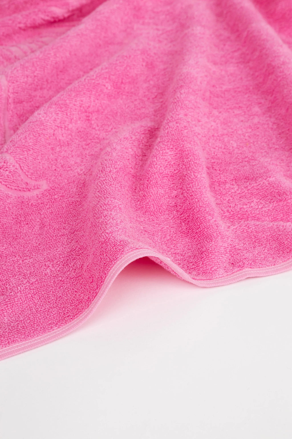 Close-up of a pink towel on a white background