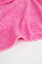 Close-up of a pink towel on a white background