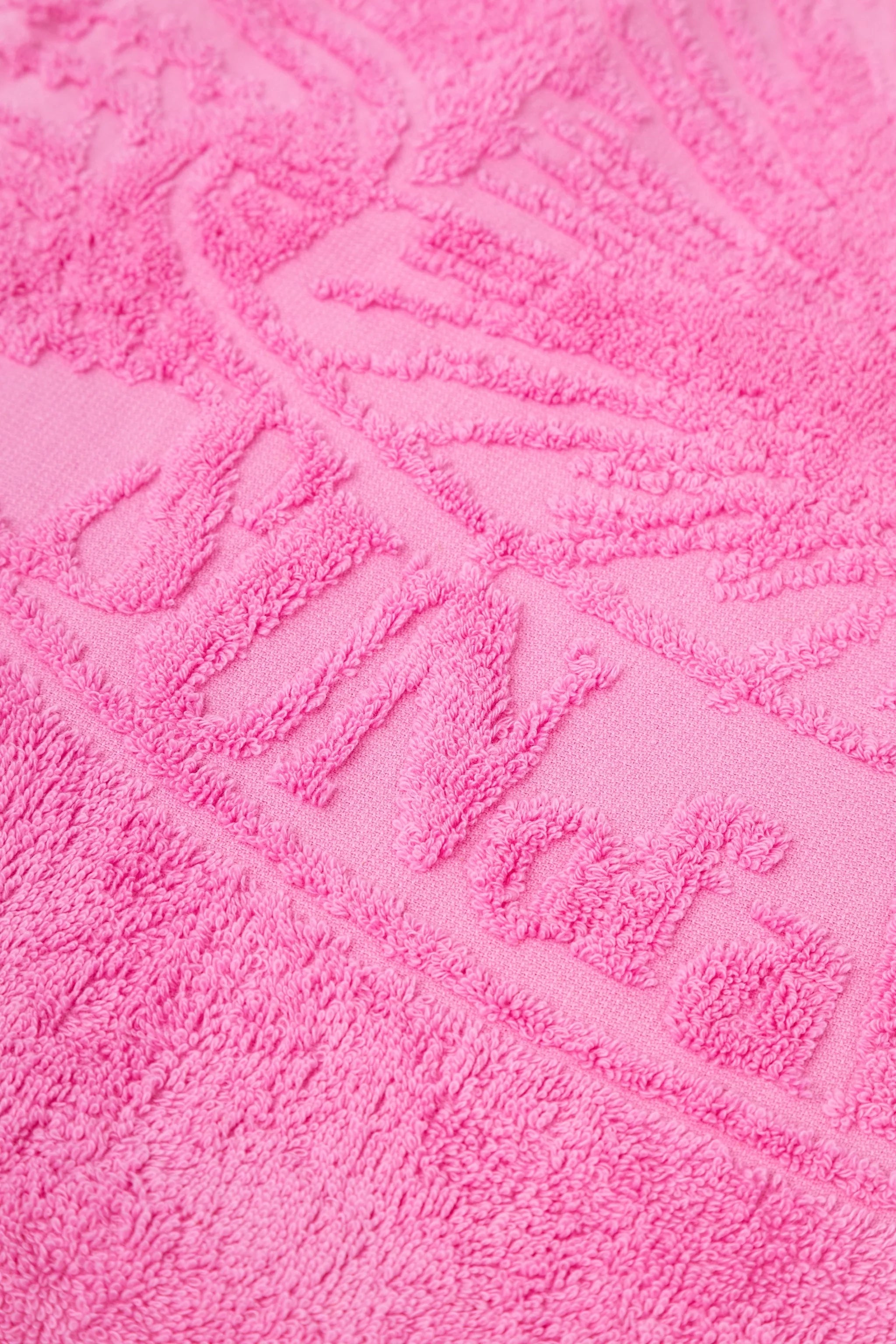 Close-up of a textured pink towel with a pattern